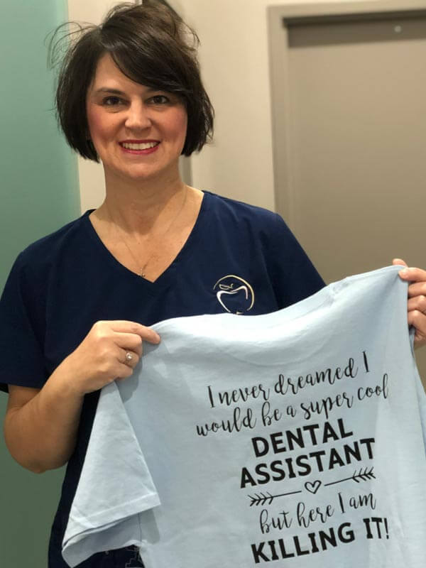 We Have Fun! Lisa dental assistant holding a shirt