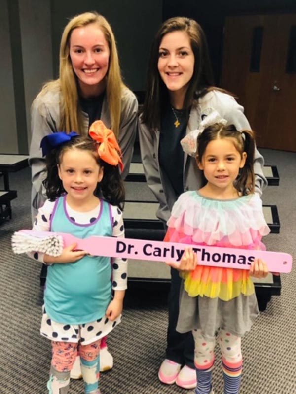 We Have Fun! pediatric patient holding large Carly Thomas DDS toothbrush