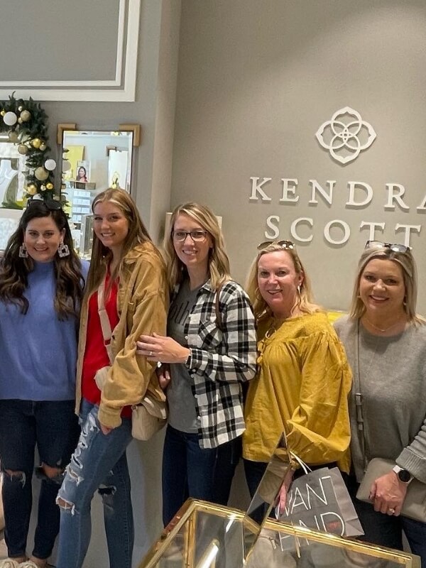 We Have Fun! Staff in front of Kendra Scott sign